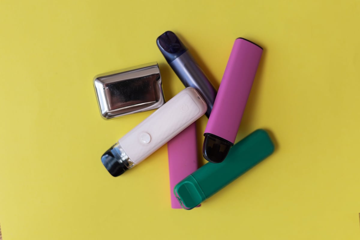Modern disposable vape devices on a clean surface