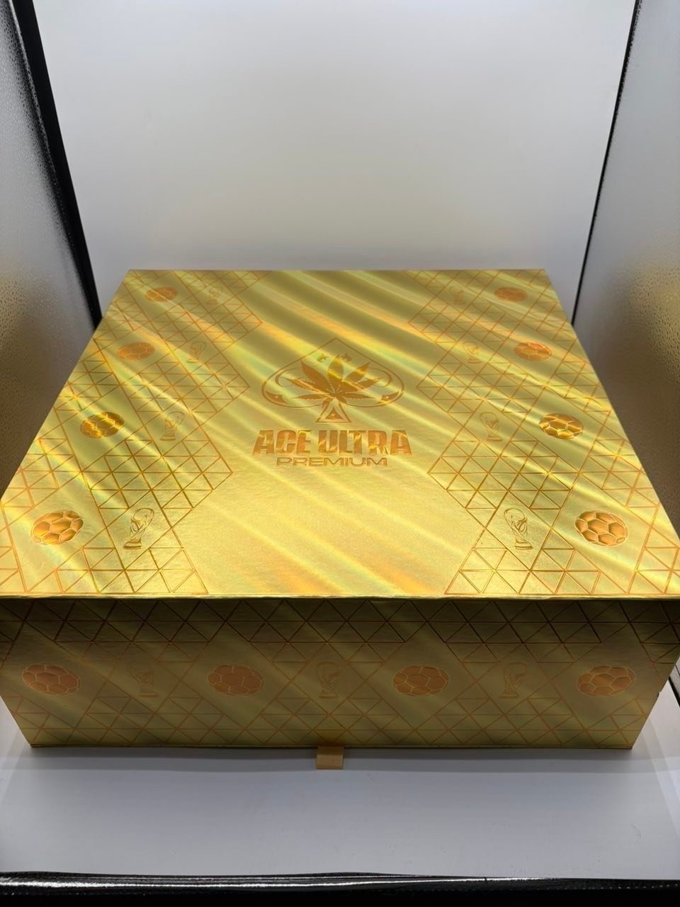 Gold premium gift box with a diamond pattern displayed on a white surface