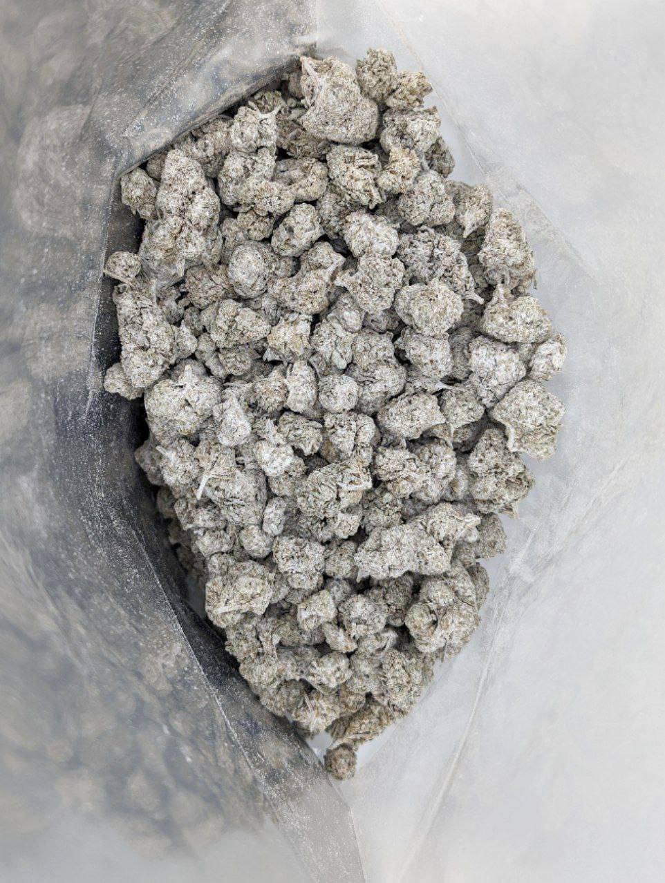 Overhead view of a sealed bag filled with THC-coated Starburst Runtz snowballs