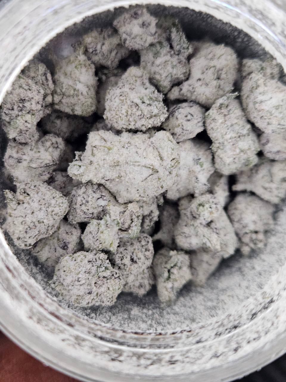 Overhead view of Persy Mini Snowballs filling a tub, each bud heavily coated in white frosting